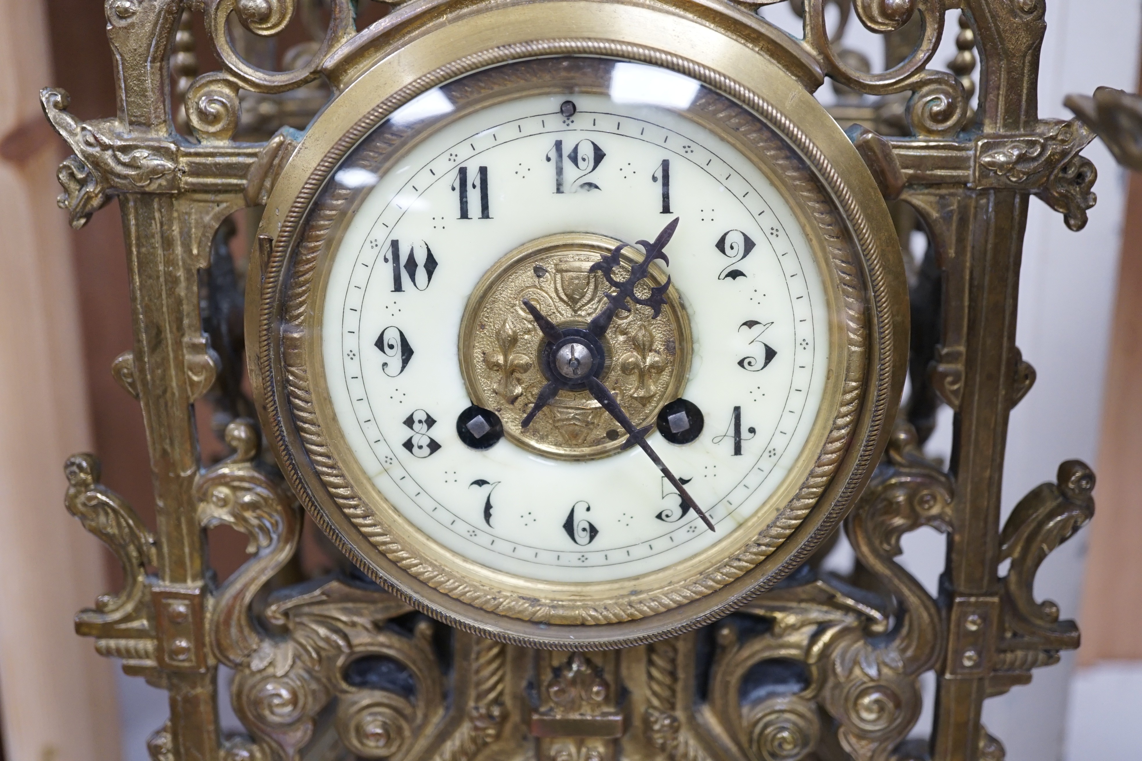 A French Gothic revival bronze clock garniture, c.1900, 56cms high